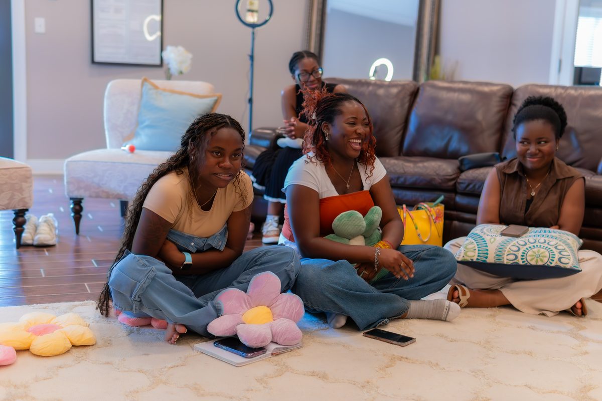 Women sitting on floor laughing together